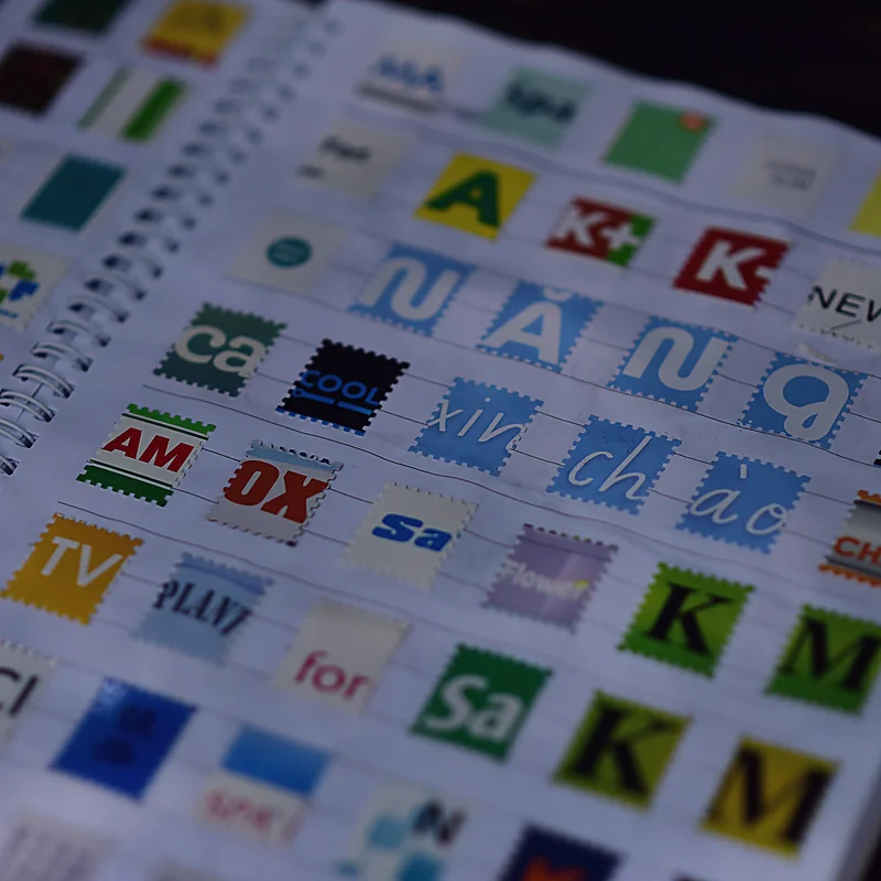 A designer's notebook filled with collected logo marks, studied for a brand identity