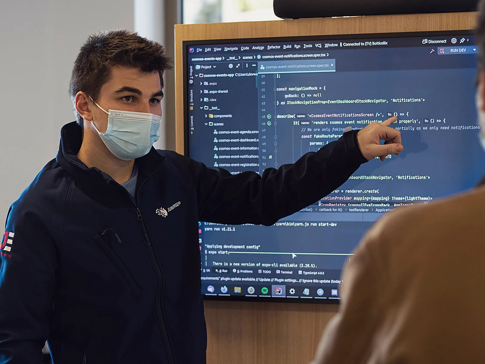 An instructor teaching a lesson one-on-one at a large screen